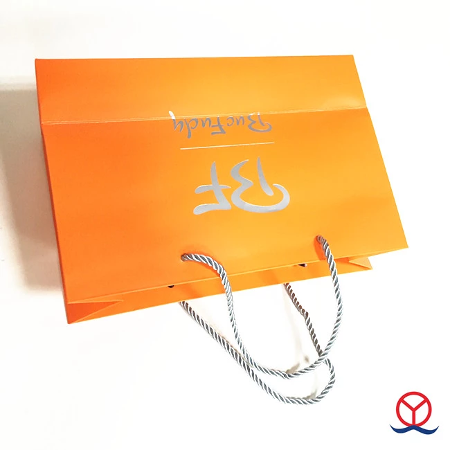 China Guangzhou Embossing and logo gold foil custom printed Orange high quality paper gift bag