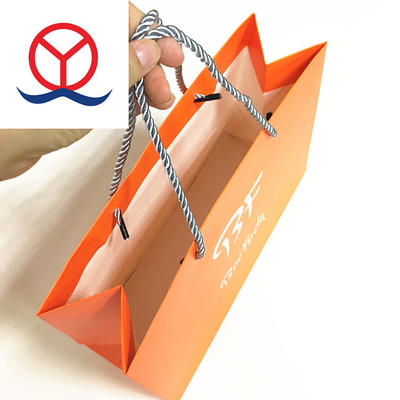 China Guangzhou Embossing and logo gold foil custom printed Orange high quality paper gift bag